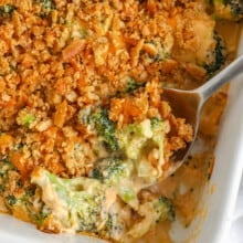 cooked Cheesy Broccoli Casserole in the dish with a spoon