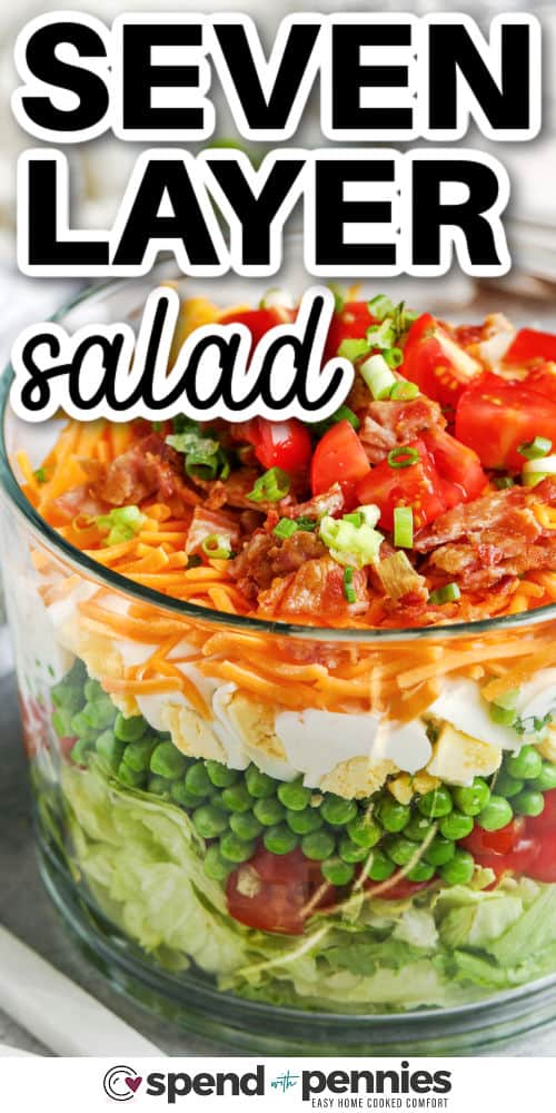 glass bowl filled with a 7 Layer Salad and a title