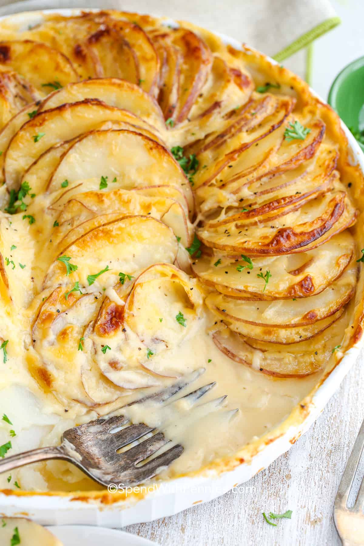 a dish of gratin potatoes with a fork