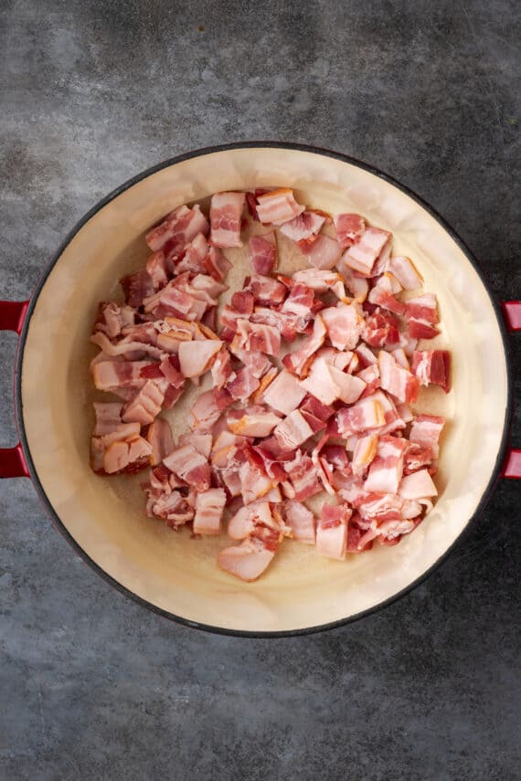 Diced bacon inside a large pot.