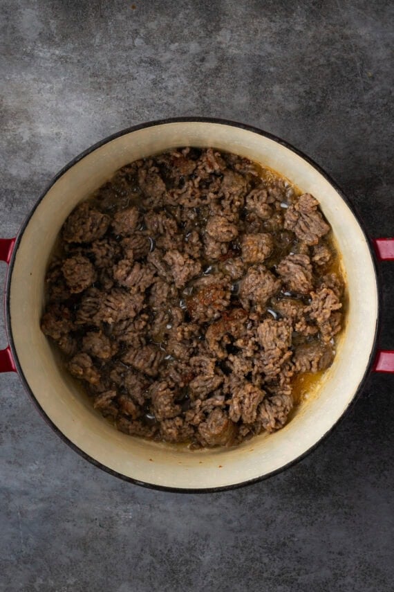 Browned sausage inside a large pot.