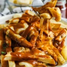 plated Homemade Poutine with some on a fork