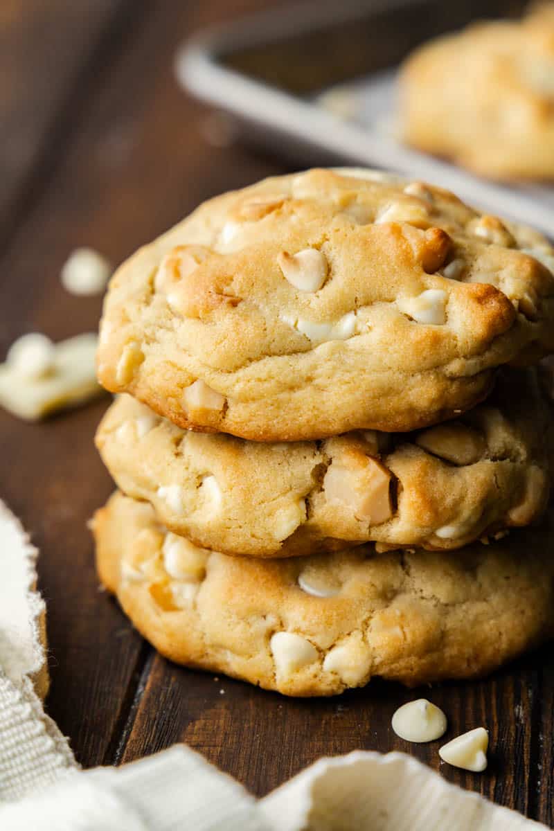 A stack of three white chocolate macadamia nut cookies.