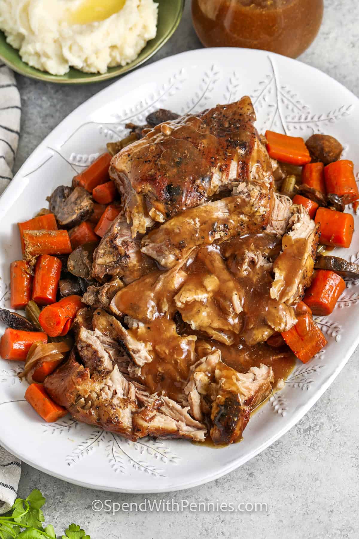 plate of Crock Pot Pork Roast with gravy and carrots