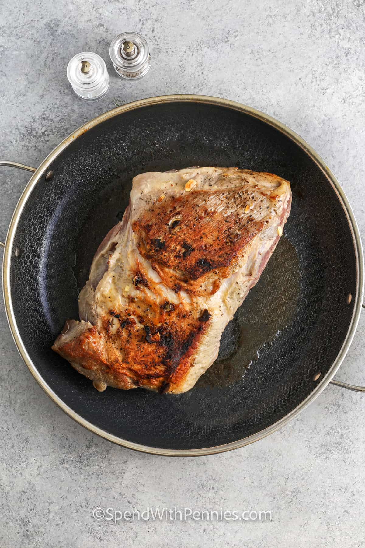 cooking pork roast on a pan before adding to pot to make Crock Pot Pork Roast