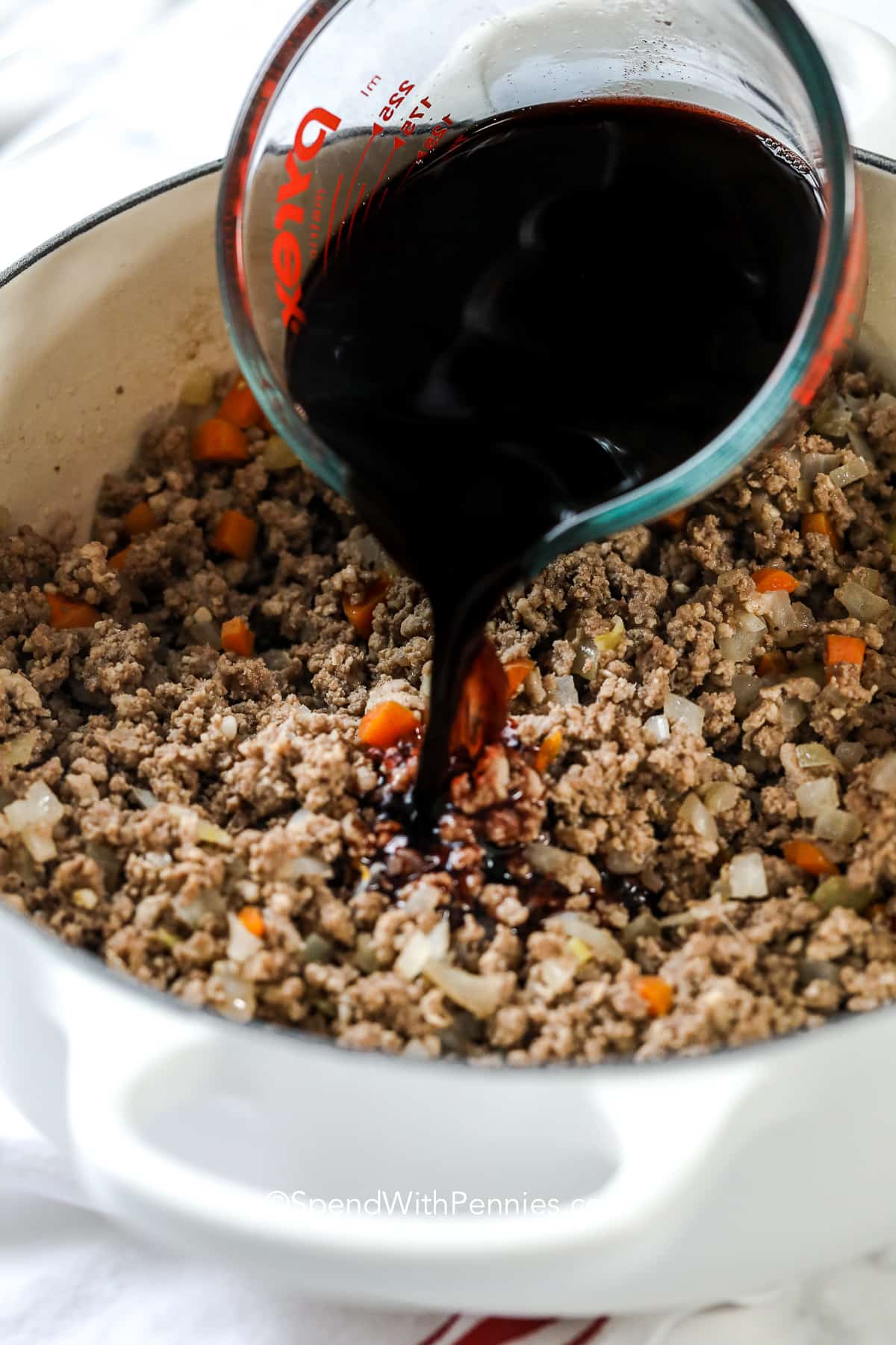 adding wine to cooked meat for bolognese