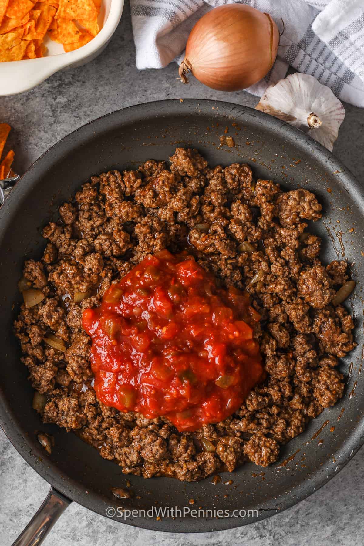 cooking beef to make Layered Dorito Casserole