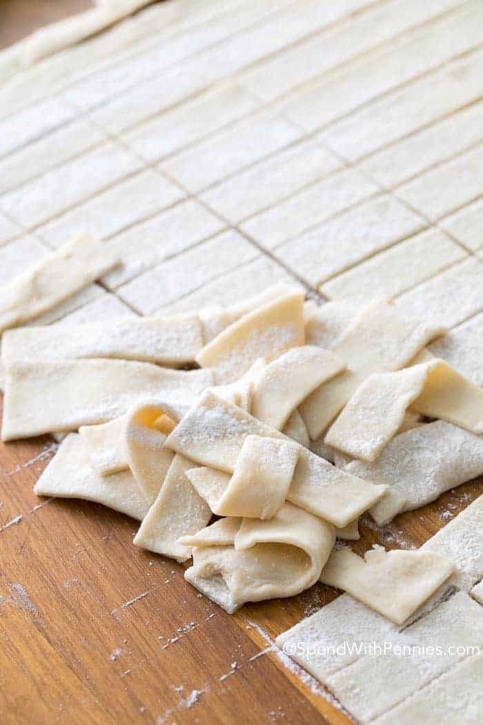 Lots of dough strips on a cutting board