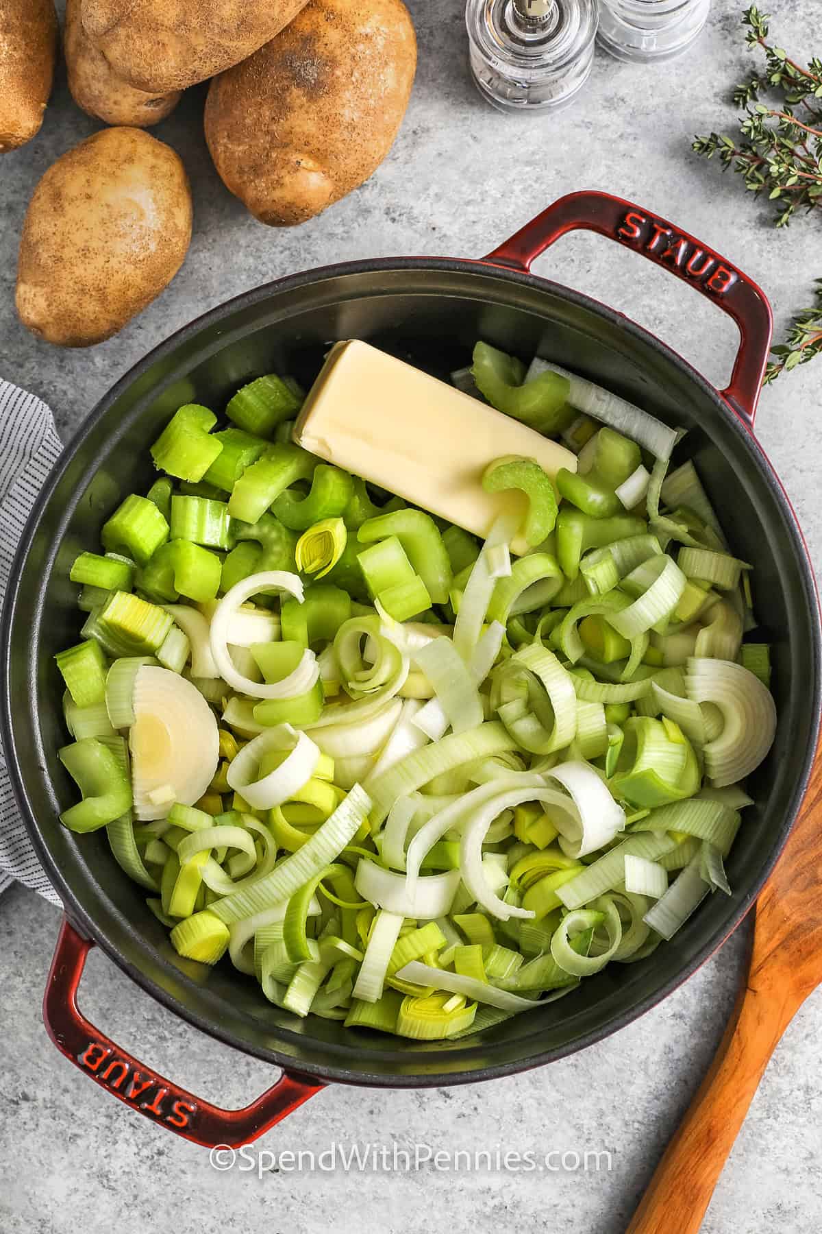 adding leeks , onion , celery and butter to pot to make Potato Leek Soup