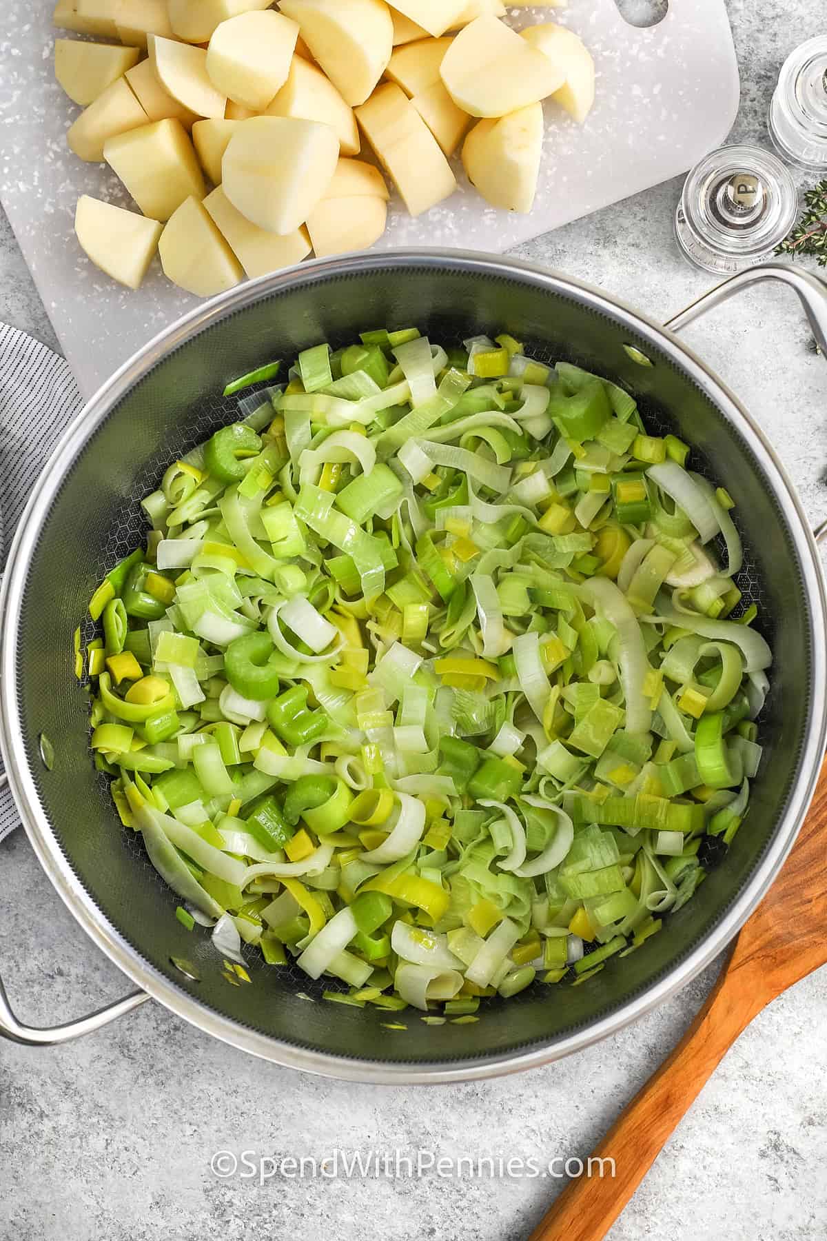 adding vegetables to pot to make Potato Leek Soup