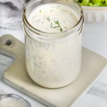 jar of Ranch Dressing Recipe with salad in a bowl