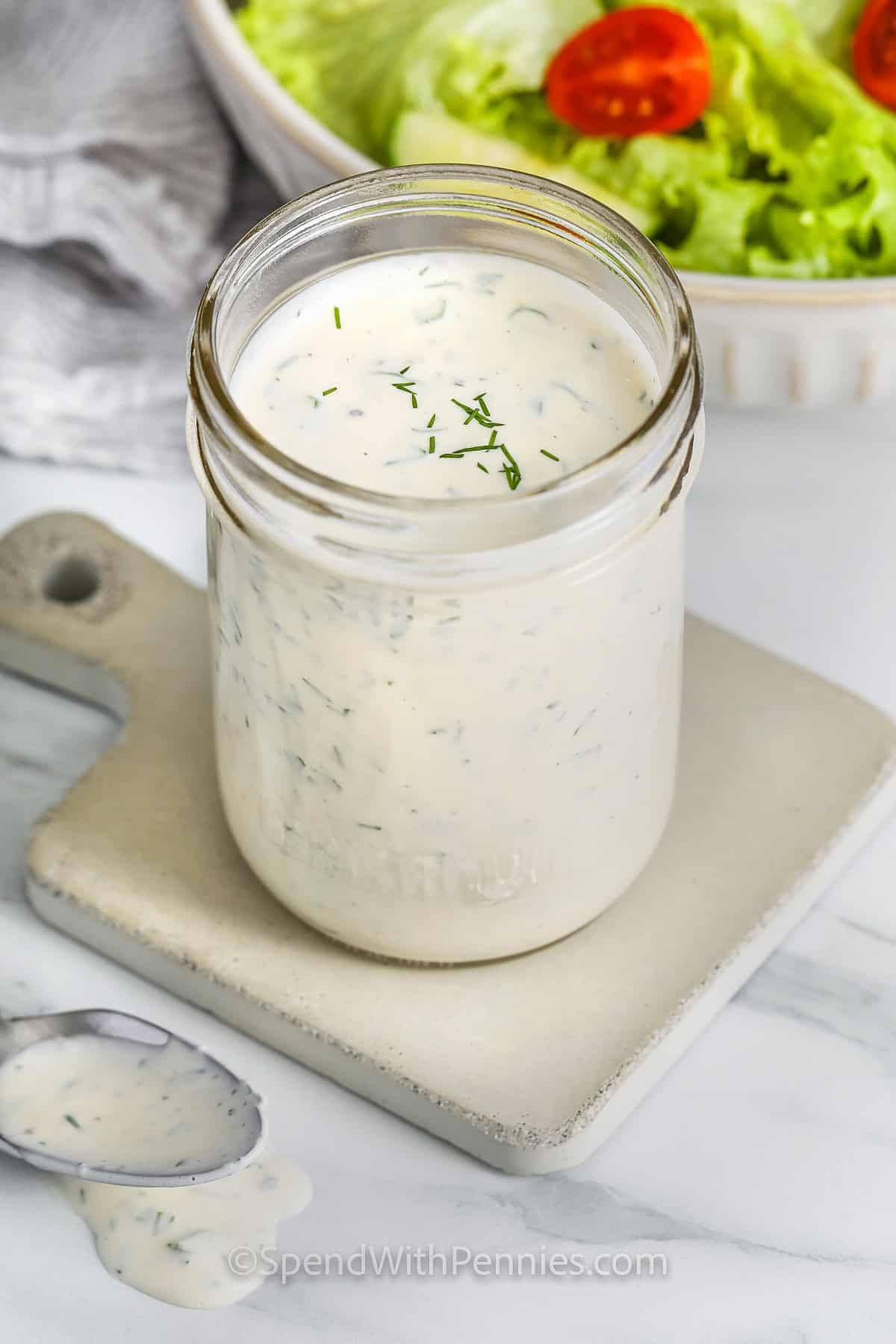 jar of Ranch Dressing Recipe with salad in a bowl