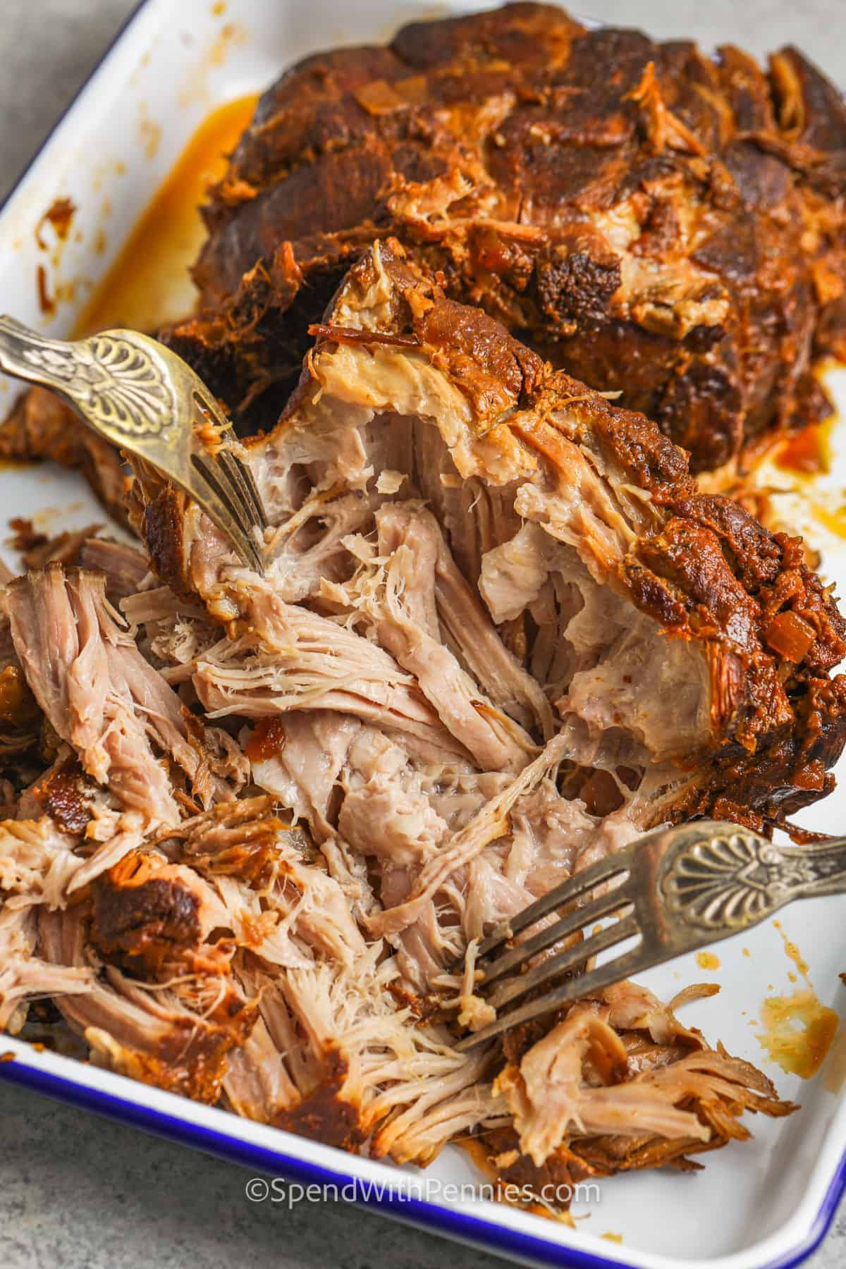 shredding pork to make Slow Cooker Pulled Pork Sandwiches