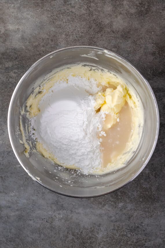 Coconut frosting ingredients added to a mixing bowl.