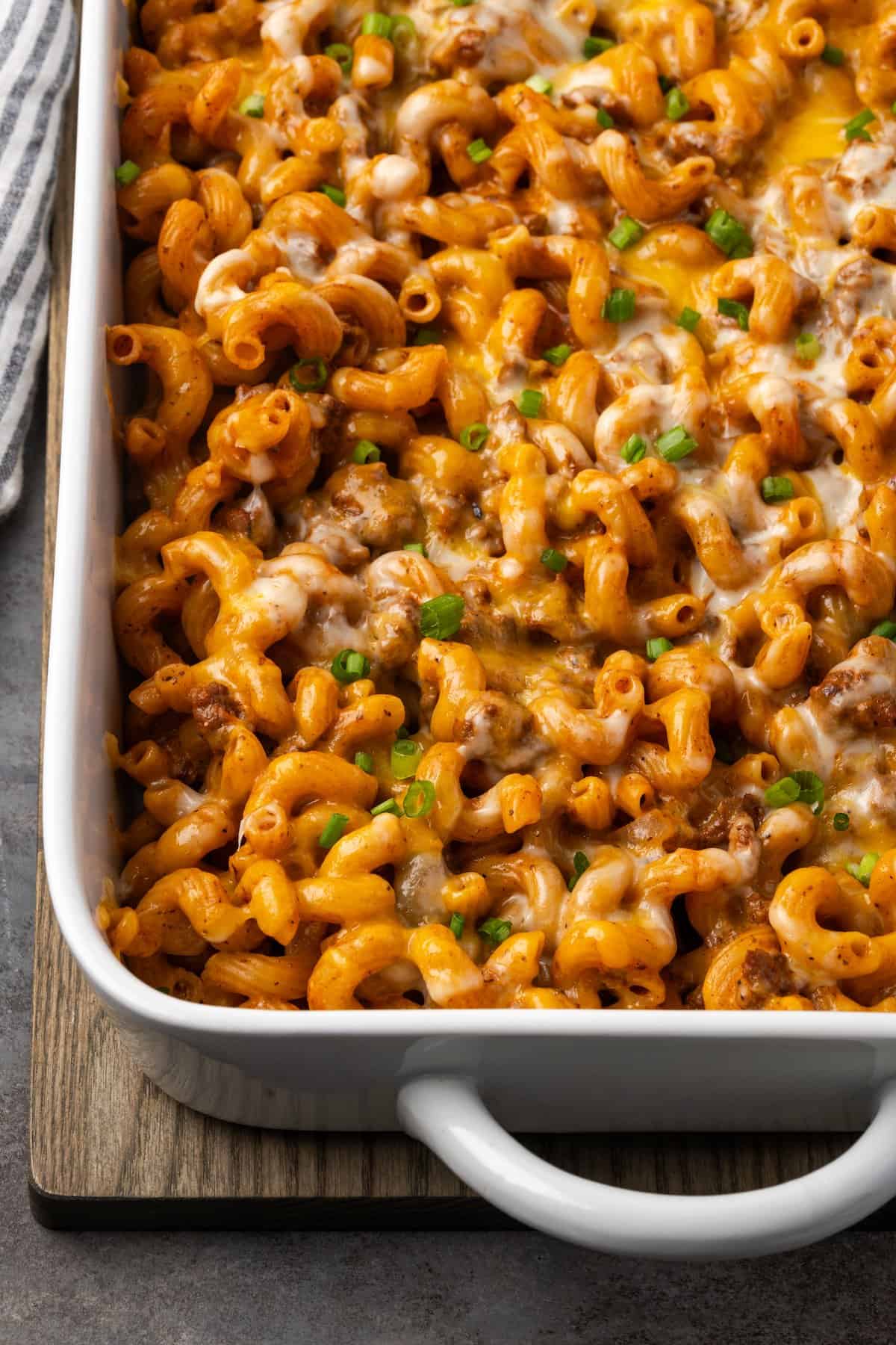 Overhead view of baked cheeseburger casserole in a ceramic baking dish.