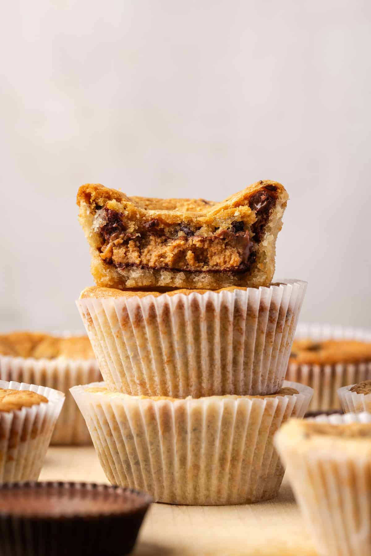 Three cookie cups stacked with a bite missing from the top cookie cup.