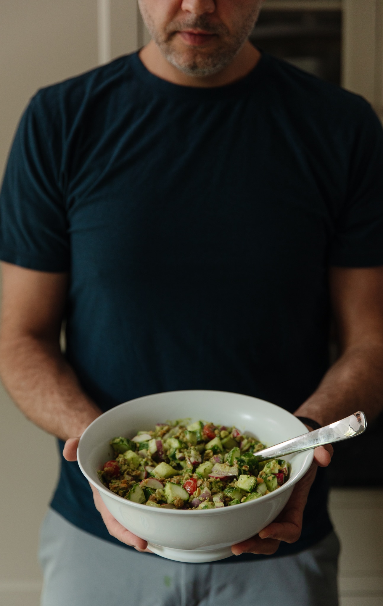 Chris holding a bowl of Cucumber Crunch Salad