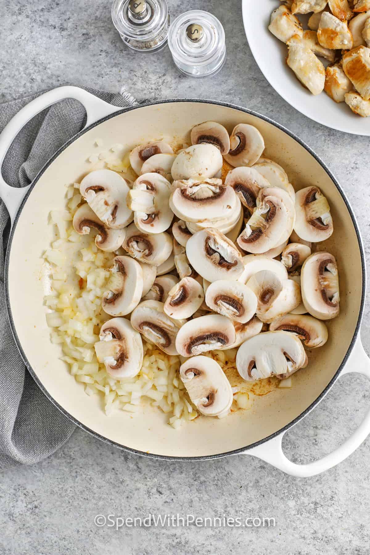 adding mushrooms to onions in pot to make Chicken Stroganoff