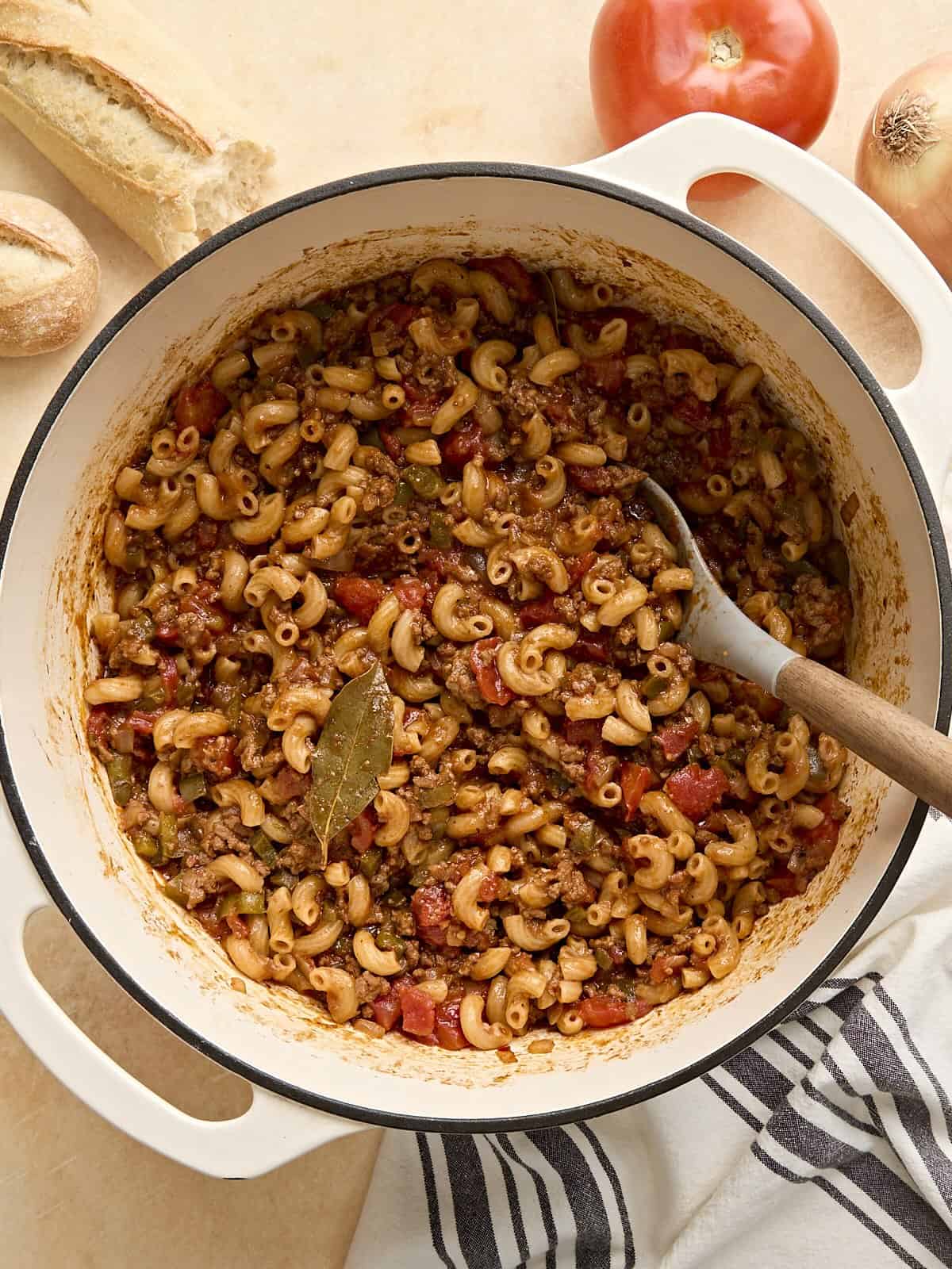 This easy one pot version of American Goulash cooks the pasta and beef in the same pot with a homemade red wine tomato sauce for extra flavor. Budgetbytes.com Overhead view of a pot of homemade American goulash with a wooden spoon.