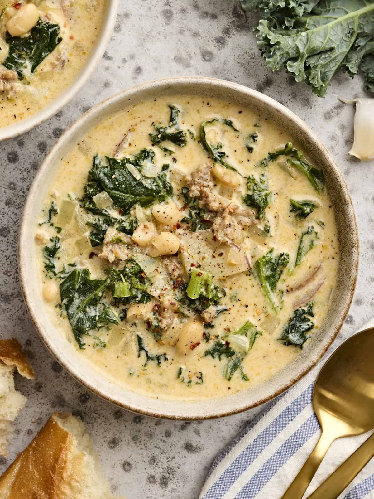 This homemade version Olive Garden's Zuppa Toscana is slightly lighter, but every bit as creamy, filling, and flavorful as the original! Budgetbytes.com Overhead view of a bowl of homemade zuppa toscana.